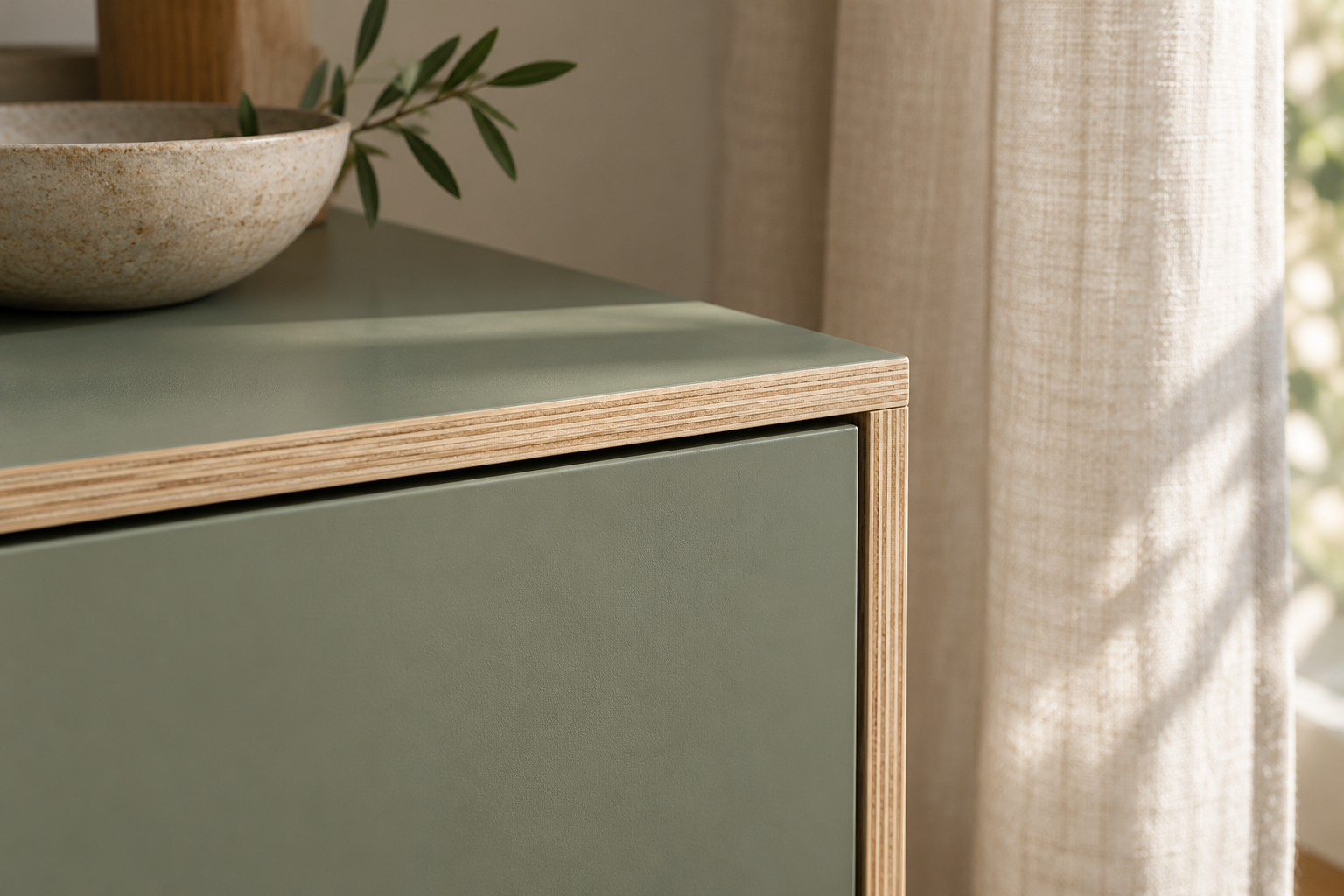 Sage matt furniture finish with an exposed plywood edge