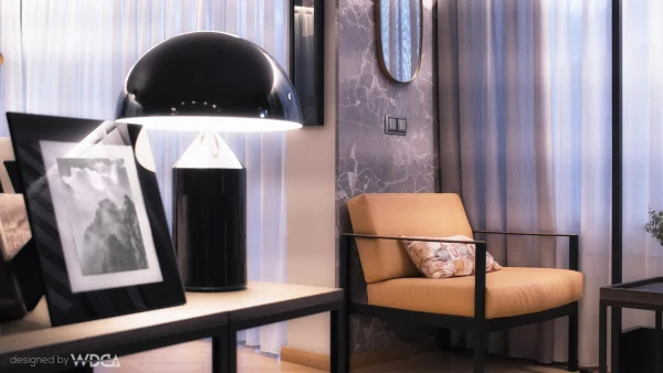 Living room with orange armchair and black dome lamp