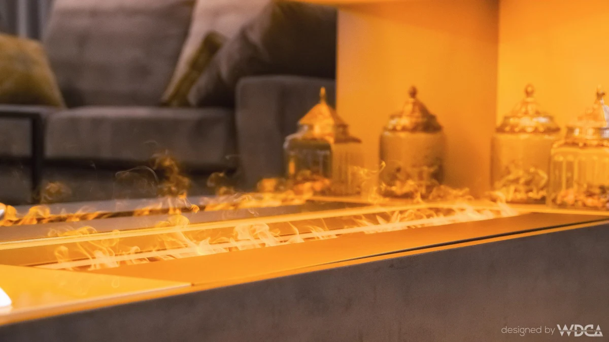 Decorative objects beside a lit fireplace